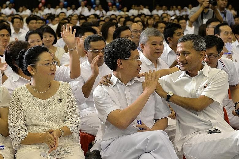 Minister for Transport Lui Tuck Yew being given a pat on the back by Environment and Water Resources Minister Vivian Balakrishnan when PM Lee thanked him for his service to the party.