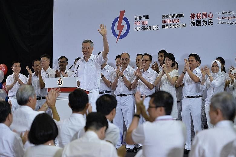 Above: Party members applauding yesterday after PM Lee introduced all the new PAP candidates. Right: PM Lee introducing former defence force chief Ng Chee Meng as a new member of the PAP. Ms Tin Pei Ling, who gave birth just three weeks ago, said she