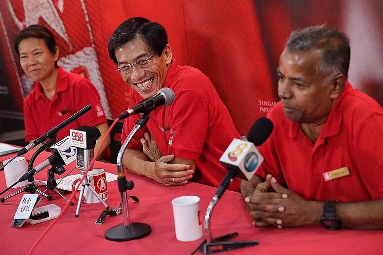 Singapore Democratic Party's secretary-general Chee Soon Juan (centre) introducing candidates Wong Souk Yee and Sadasivam Veriyah yesterday. Mr Chee also formally announced that he will be contesting the coming general election.
