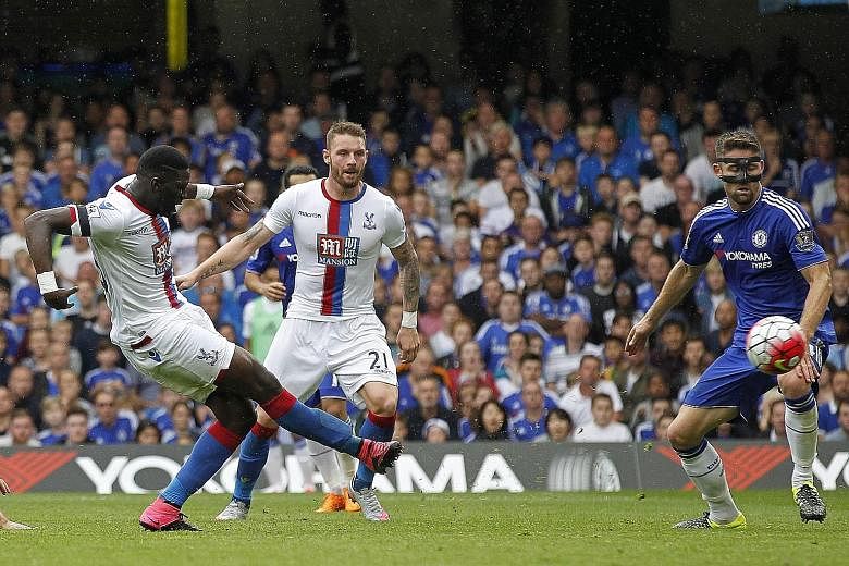 Crystal Palace's French midfielder Bakary Sako (left) scores his team's first goal during the shock 2-1 win against Chelsea at Stamford Bridge yesterday. The Blues' paltry total of four points from four games represents their worst start to a season 