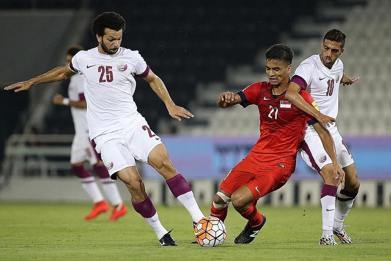 The Lions, with Safuwan Baharudin (centre) in the thick of action, went down 0-4 to Qatar in a friendly match in Doha, ahead of their World Cup qualifier against Syria.