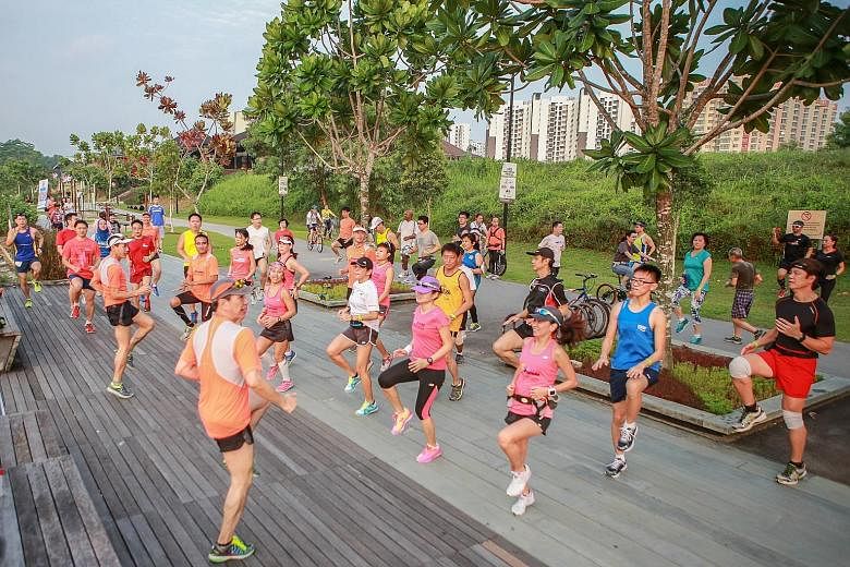 Participants in the 18.45km category of the ST Run at the Hub warming up before their second training session yesterday at the Punggol Promenade. Led by the event's official pacers from local running group Team FatBird, they ran about 12km along the 