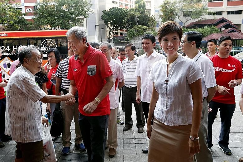 Dr Ng Eng Hen (in red shirt) meeting residents at Bishan North Shopping Mall yesterday. Dr Ng said he sensed that the mood on the ground towards the PAP is better than during the 2011 polls, but the party does not take any votes for granted.