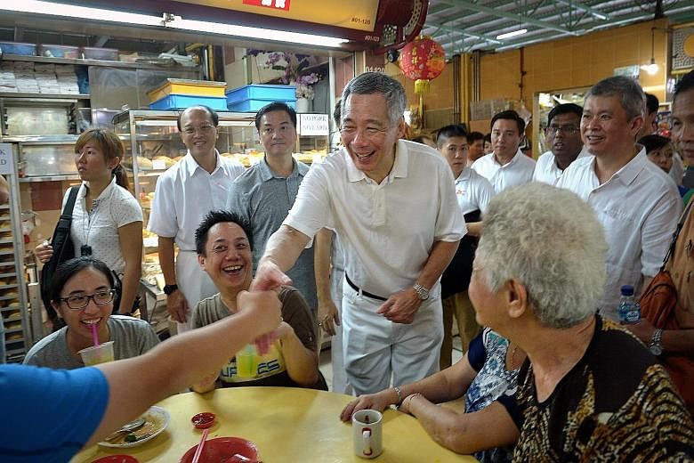 PM Lee greeting residents at the Cheng San market in Ang Mo Kio Avenue 10, as he led the Ang Mo Kio GRC candidates in three market visits.