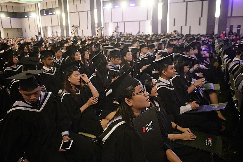 Graduates at the SIM-RMIT University degree conferment and awards ceremony for Bachelor of Business (Management) held at the Singapore Institute of Management last Thursday.