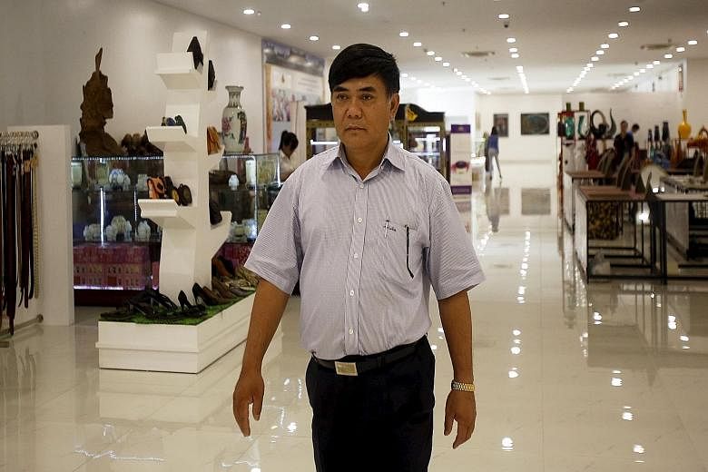 Mr Nguyen Huu Duong in a store in his building in Hanoi, Vietnam, last Saturday. He said he spent $38 million on the V+ mall, which opened in February. It reduces overheads to slash prices.