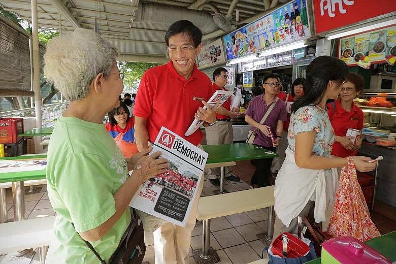 Dr Chee Soon Juan meeting a member of the public during his walkabout at Bukit Timah Market on Sunday. He says SDP aims to appeal to Singaporeans that it is important to have a competent opposition.