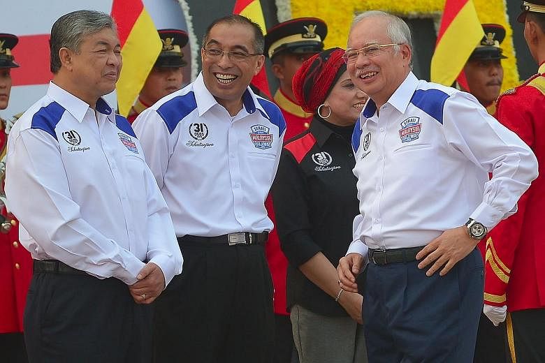 Prime Minister Najib Razak (right), with his deputy Ahmad Zahid Hamidi (left) and Communications and Multimedia Minister Salleh Said Keruak, at Dataran Merdeka in Kuala Lumpur before the start of Independence Day celebrations yesterday. Malaysia's 58