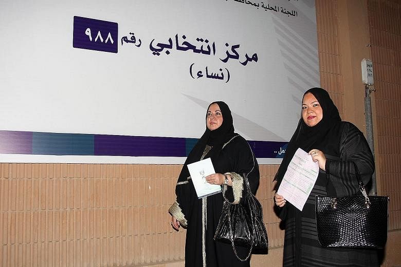 Saudi women with their applications on their way to register to vote in the port city of Jeddah on Sunday. Saudi Arabia is also allowing women to stand in local elections, in another first for the ultra- conservative Muslim kingdom.