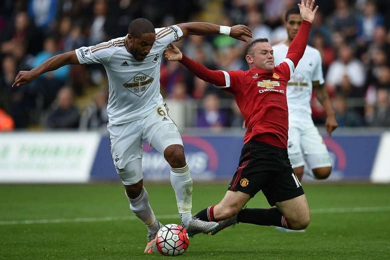 Swansea City defender Ashley Williams (left) challenges Manchester United's Wayne Rooney during the side's 2-1 victory on Sunday. The addition of French striker Anthony Martial could bring relief for Man United's woes in terms of scoring.