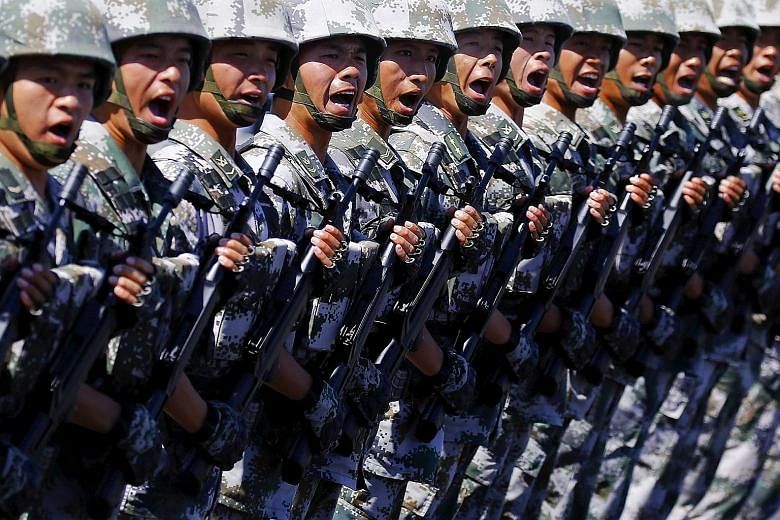 Soldiers of China's People's Liberation Army shouting as they march during a training session for a military parade to mark the 70th anniversary of the end of World War II, at a military base in Beijing recently.