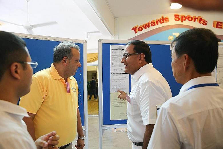 PAP's Mr S. Iswaran (right) alerting Reform Party chief Kenneth Jeyaretnam to a mistake in the team's nomination form yesterday.