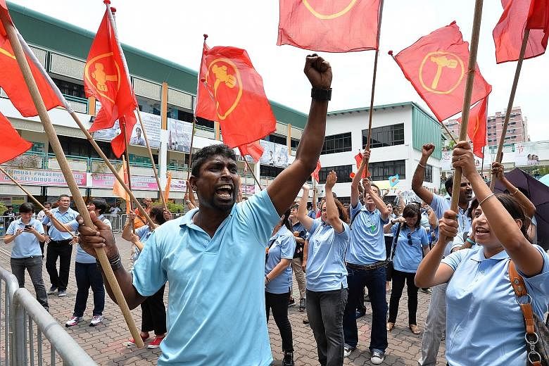 Workers' Party supporters at the Poi Ching nomination centre yesterday where the party filed nomination papers for Mr Png Eng Huat for Hougang SMC.