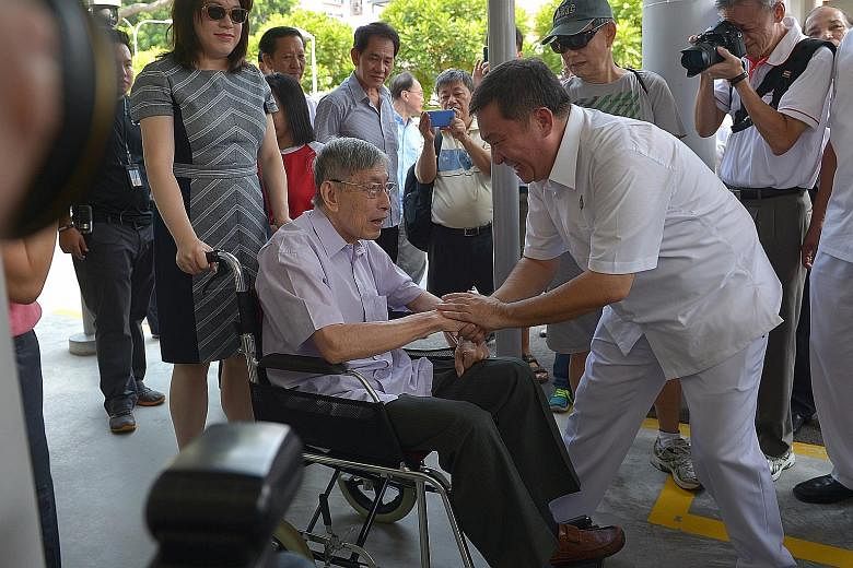 PAP candidateSitoh Yih Pin greeting Mr Chiam See Tong, who arrived in a wheelchair with his daughter Camilla, at the nomination centre in Kong Hwa School yesterday.