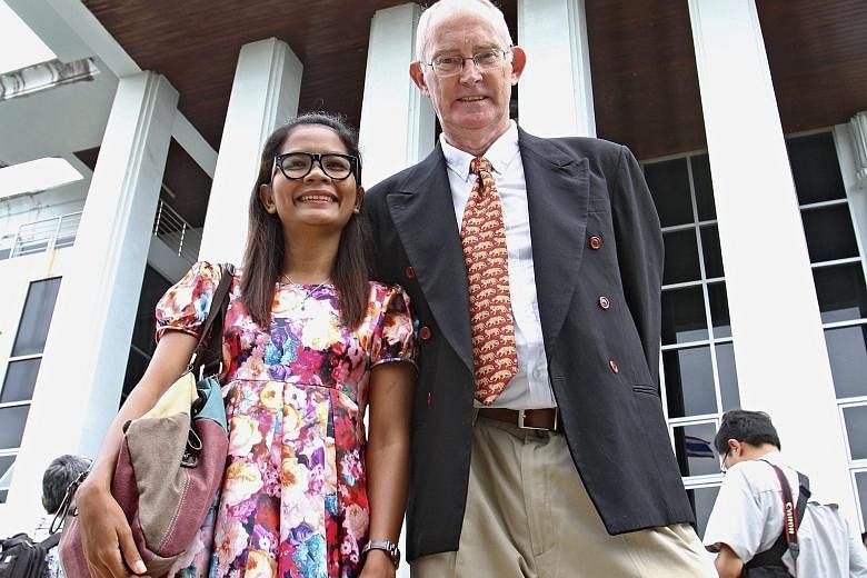 Mr Alan Morison, editor of the Phuketwan website, and reporter Chutima Sidasathian outside the provincial court in Phuket yesterday. They were facing up to seven years in jail.