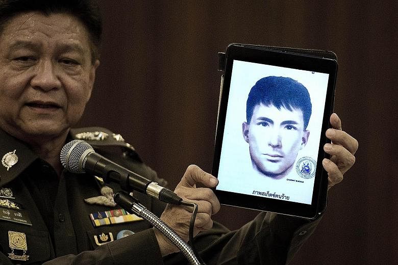 Thailand's national police spokesman Prawut Thavornsiri with a tablet displaying a picture of Ali Jolan, a foreign man wanted in connection with the Aug 17 bombing of the Erawan Shrine in Bangkok. Thai police have issued an arrest warrant for Turkish