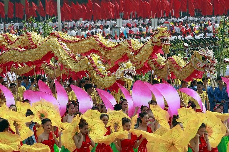 Performers taking part in a dragon dance during the parade marking Vietnam's 70th National Day at Ba Dinh square in Hanoi yesterday. More than 30,000 people, from soldiers to schoolgirls, marched in a lavish parade that was one of the country's large
