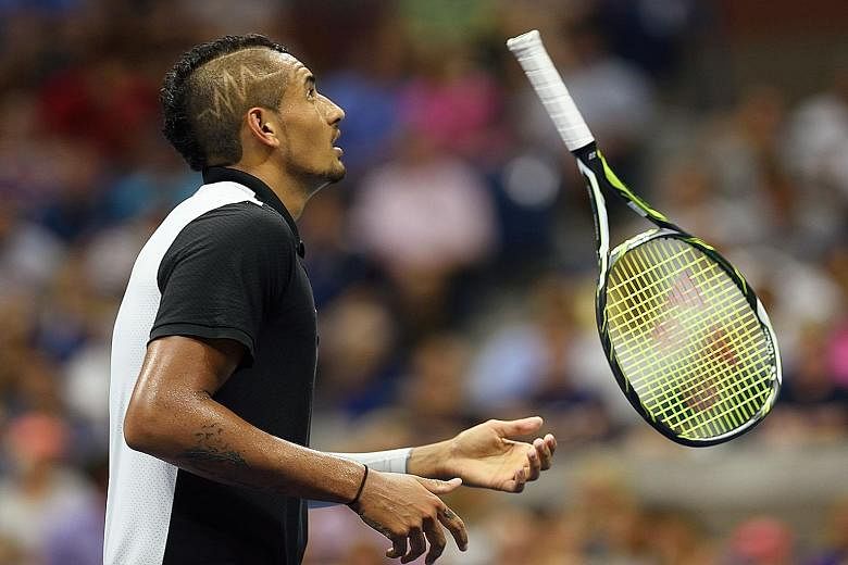Nick Kyrgios tosses his racket during his four-set loss to Andy Murray in the first round of the US Open yesterday.