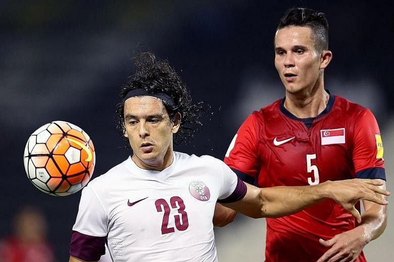 Singapore, with defender Baihakki Khaizan (right) in action against Qatar's Sebastian Soria, showed their defensive mettle in the first half before fatigue sapped them in the second half. The Lions eventually lost 0-4 in the friendly in Doha last Fri
