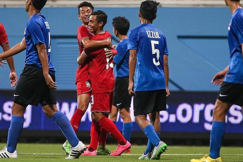 Thai players (in red) celebrating another goal during their 5-0 victory over Singapore in their AFC U-16 Championship qualifier at Jalan Besar Stadium.