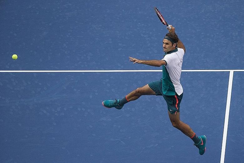 World No. 2 Roger Federer of Switzerland is airborne as he prepares to hit a smash during his 6-1, 6-2, 6-2 victory against Leonardo Mayer of Argentina in the first round of the US Open.