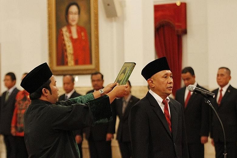 Mr Teten Masduki being sworn in as the Indonesian Chief of Staff at the presidential palace yesterday, taking over from Mr Luhut Pandjaitan who last month took over a key role as the coordinating minister for security and political affairs.