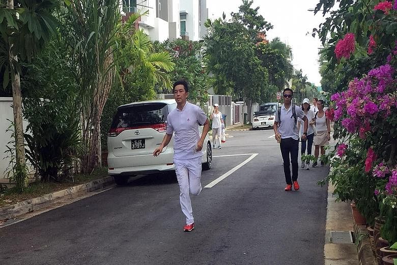 Mr Tan Chuan-Jin, PAP candidate for Marine Parade GRC, ran from house to house in order to meet more residents in their homes.