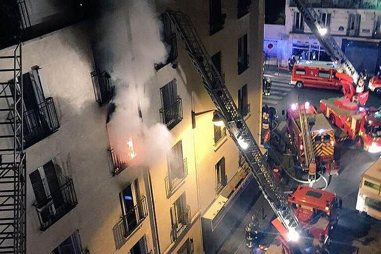 Firemen fighting a blaze that killed eight people, including two children, at an apartment building in north Paris early yesterday. Officials say the fire in the 18th district of the French capital might have been started intentionally. Investigators