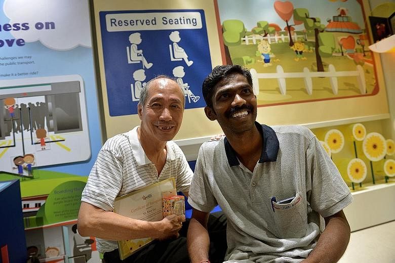 Mr Rimy Lau with Mr Saravanan Samidurai at the Singapore Kindness Movement's gallery yesterday. Mr Lau was presented with a certificate commending his gesture.