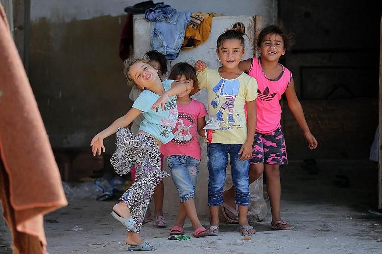 Syrian refugee children playing at an unofficial refugee camp in the northern Lebanese city of Tripoli, north of capital Beirut, on Wednesday.