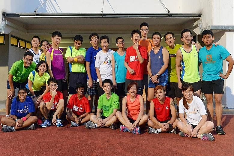 A member of the Special Olympics Singapore running club, Salihin Sinai (second row, first from right) will run 10km in the ST Run. His volunteer coach, Yeo Jia Chyang (second row, third from right) will be running with the dental technician.