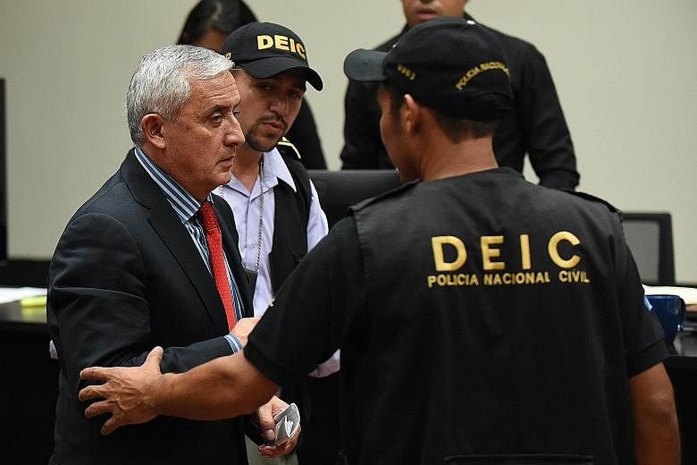 Guatemala's former president Otto Perez Molina (left) being taken away at the end of a hearing at the Supreme Court in Guatemala City on Thursday. He was sent to Matamoros prison, which is on a military base there.