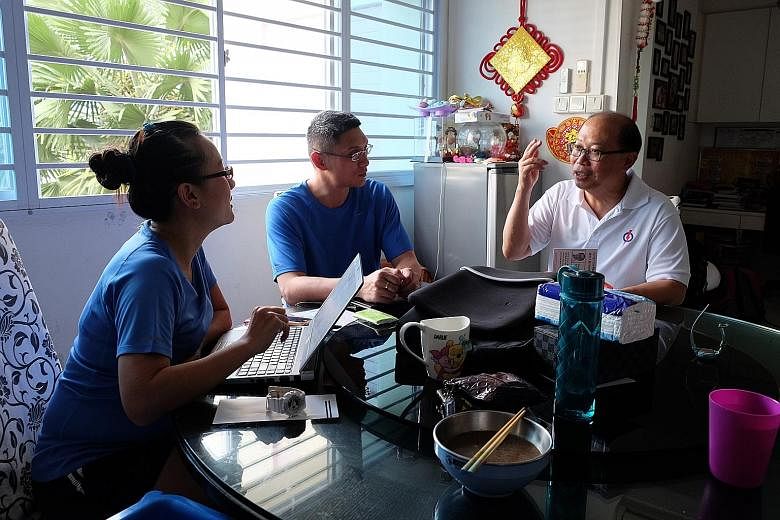 (Clockwise from far left) Mrs Serene Seah, 35, and Mr Seah Seng Siong, 37, discuss the issues they are facing with Mr David Ong during his visit to their home. The PAP's Mr Ong is up against SDP's Mr Sadasivam Veriyah and independent Samir Salim Neji