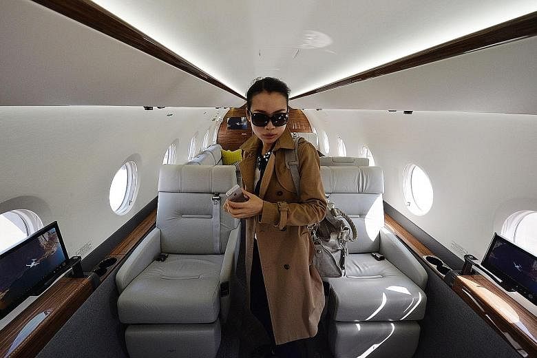 A Chinese woman in a private luxury business jet at Shanghai's Hongqiao airport. China's rapid economic growth has produced a wealthy elite whose members can afford to send their children to the US and even pay full college tuition.