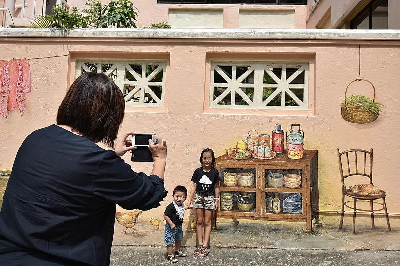 Dr Victor Choa (above, left) allowed his property's walls to be used as a canvas for Mr Yip Yew Chong (above, right) to paint the murals, such as of a barbershop scene and a Milkmaid can "hanging" from a pipe (left). Careers manager Angeline Sim (abo