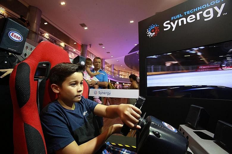 Singapore's junior go-kart racer Ryan Chapman, 11, tried his hand at a race-car simulator at the Esso Synergy Race Off event at ION Orchard yesterday, and clocked one of the day's fastest times. The event celebrates Esso's recent launch of its Synerg