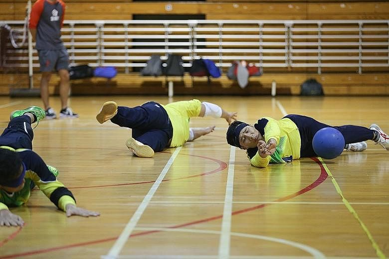 Despite being visually impaired, goalball athletes such as Kelvin Tan (right) are able to hear the bell inside the ball and block their opponent's goal attempts.