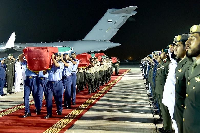 Members of the Emirati armed forces carry the coffins of fallen comrades during an official repatriation ceremony in Abu Dhabi. The men were killed last Friday in Yemen's eastern province of Marib.