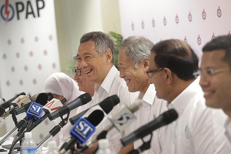(From far left) Madam Halimah Yacob, Mr Lim Swee Say, Prime Minister Lee Hsien Loong, Dr Ng Eng Hen, Mr S. Iswaran and Mr Desmond Lee at a press conference at the PAP's headquarters yesterday. Senior PAP leaders, such as Dr Ng, put potential candidat