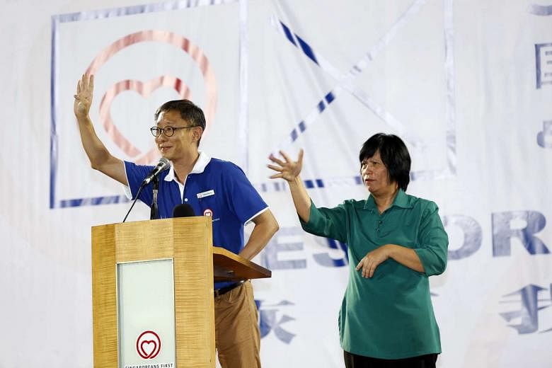 Mr Wong Chee Wai of the Singaporeans First party at its rally last Thursday, with an interpreter for those who cannot hear. 