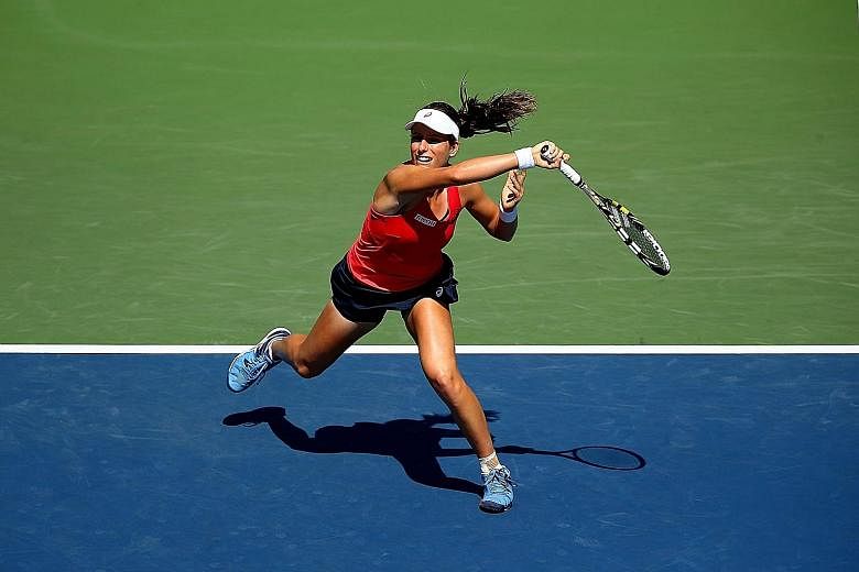 Johanna Konta of Britain hits a forehand against 18th seed Andrea Petkovic of Germany during her upset 7-6, 6-3 victory in the third round of the US Open on Saturday.