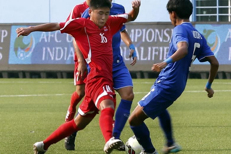 North Korea Under-15 midfielder Kwon Nam Hyok (in red) getting the better of his Thai opponents in a 2-0 win. The North Korean players are known for their tall and powerful frames despite their young age.