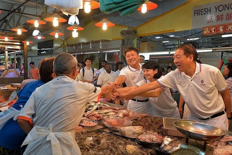 (From left) The PAP's Mr Ng Chee Meng, Ms Sun Xueling and DPM Teo Chee Hean greeting stallholders at a wet market in Punggol yesterday. The other three Pasir Ris-Punggol GRC candidates - Mr Teo Ser Luck, Dr Janil Puthucheary and Mr Zainal Sapari - al