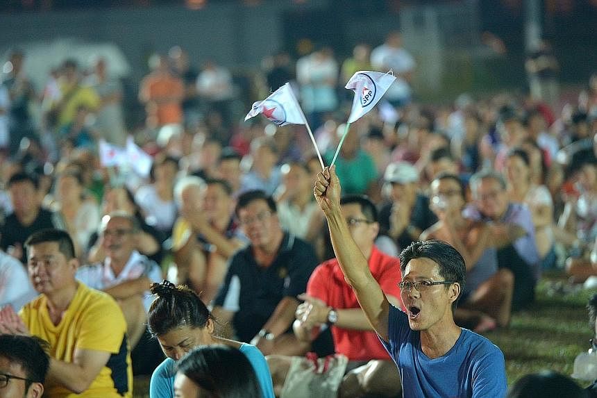 They went, they waved, they wore their stripes. Clockwise from above: Reform Party supporters with its flag at its rally for Radin Mas SMC; a Singapore People's Party supporter at its rally for Mountbatten SMC; and a Singapore Democratic Party suppor