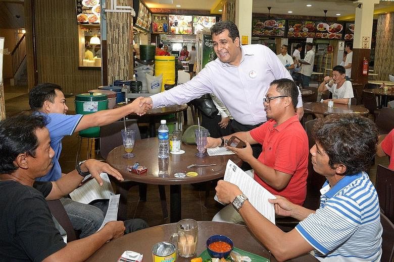 Mr Ravi Philemon (standing), the Singapore People's Party's candidate for Hong Kah North SMC, on the campaign trail. His humble family background fuels his desire to ensure social mobility for Singaporeans.