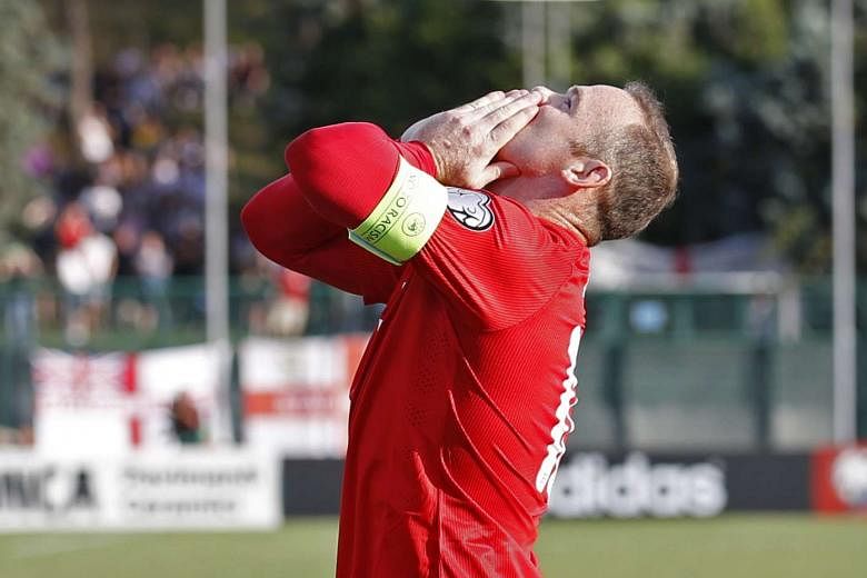 Wayne Rooney celebrates his penalty against San Marino on Saturday that enabled him to draw level with Bobby Charlton's tally. 