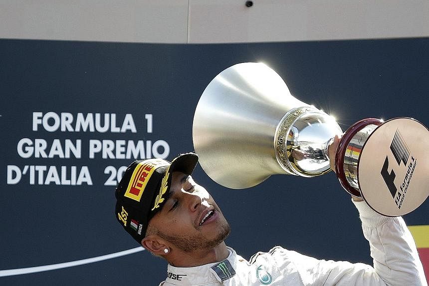 Hamilton celebrating his Italian Grand Prix win, which puts him 53 points clear of Nico Rosberg at the top of the drivers' standings. 