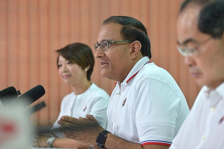 PAP West Coast GRC candidates (from left) Foo Mee Har, S. Iswaran and Lim Hng Kiang say that the Reform Party's policy proposals on foreign workers and a minimum wage would put "a fundamentally sound system" in jeopardy. Mr Iswaran said the RP's call