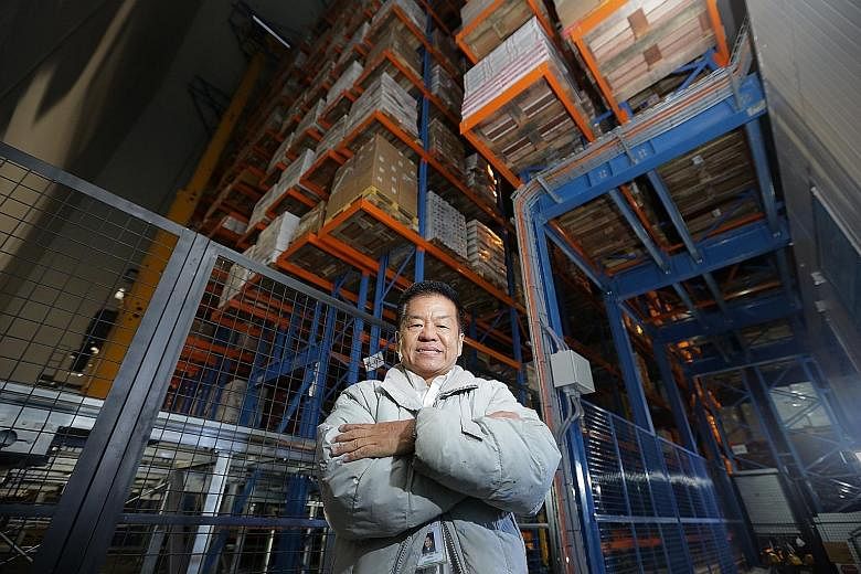 Mr Liew Yew Fah at the firm's warehouse in Mandai Link. The facility is automated so as to reduce the manpower needs of the company. It also makes better use of space so more products can be stored there.