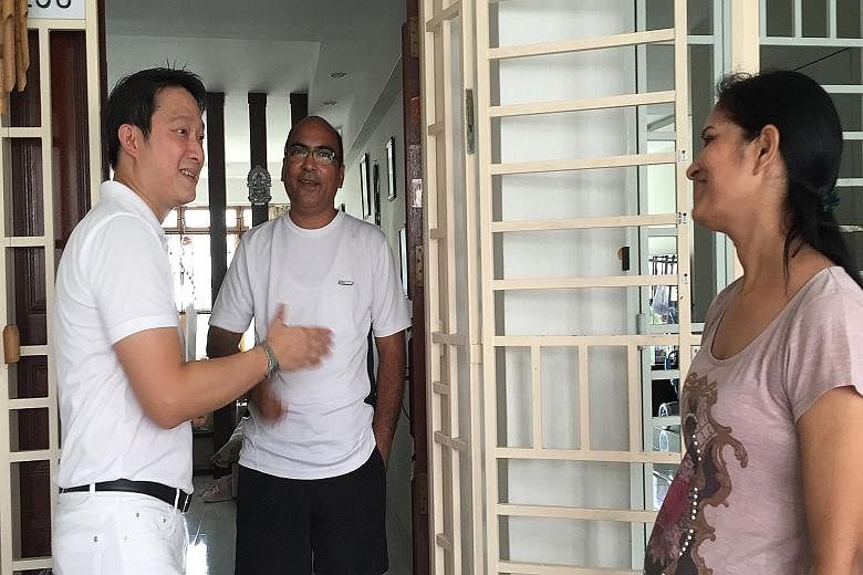 Mr Koh Choong Yong of the Workers' Party shaking the hand of a resident during a walkabout in Sengkang on Sunday. Dr Lam Pin Min of the People's Action Party visiting an Anchorvale resident during a walkabout in the ward last Saturday.
